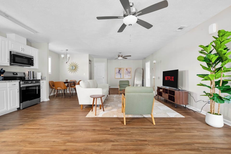Unwind in style! Our bright and modern living room is the perfect spot to relax after a day of exploring. Sink into the comfy sofa or armchairs, fire up Netflix, and feel right at home.