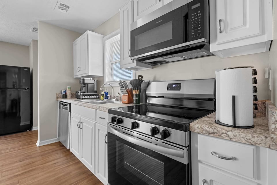 This open-concept space seamlessly blends a functional kitchen with an inviting dining area, making mealtime a breeze.