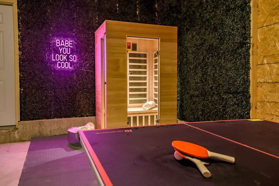 Private Infrared Sauna: Features a premium wooden sauna unit, integrated heat controls, and an adjacent ping pong table for the perfect balance of relaxation and recreation!
