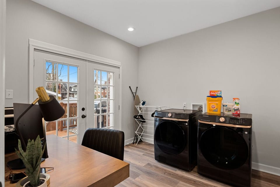 Convenient Work & Wash Station: Features a high-capacity Samsung washer and dryer, spacious wooden desk, and direct deck access—multitasking has never been this effortless!