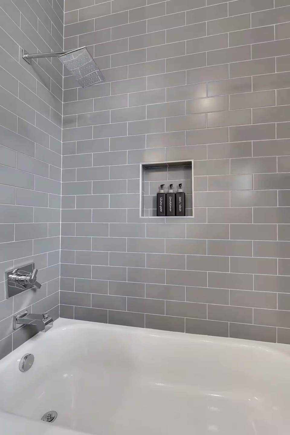 Guest bathroom w/ single vanity and shower/tub combo off living room and kitchen
