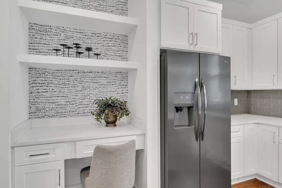 Open-concept kitchen with quartz counters, gas range, and stainless appliances.