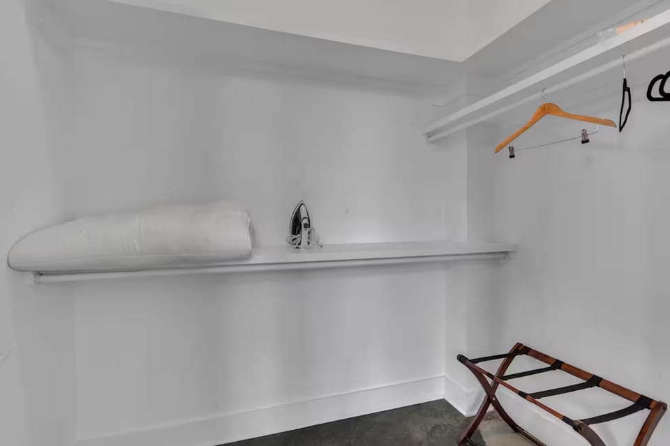 Walk-in closet w/ shelves, hangers, and luggage space.