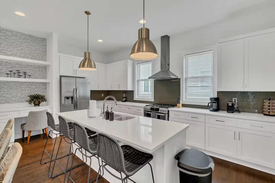 Open-concept kitchen with quartz counters, gas range, and stainless appliances.| Unit C
