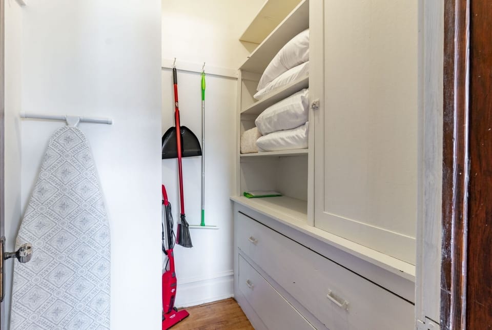 Storage closet located off of the dining area. Ironing board, broom, Swiffer.