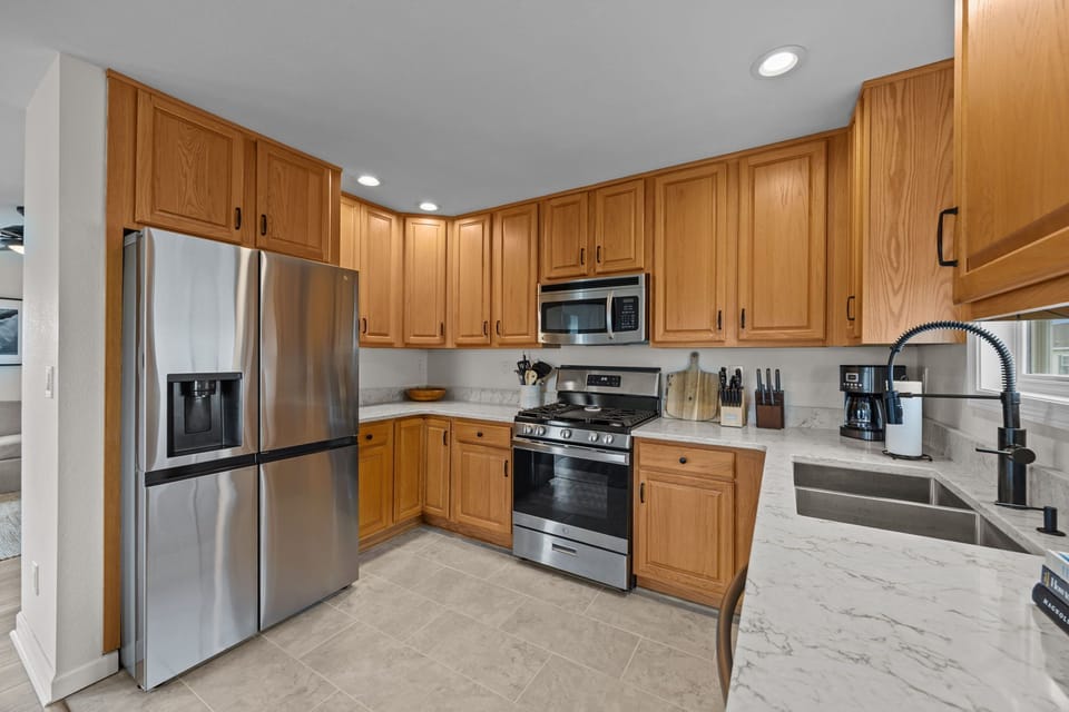 Updated Kitchen featuring gas stove and oversized refridgerator 