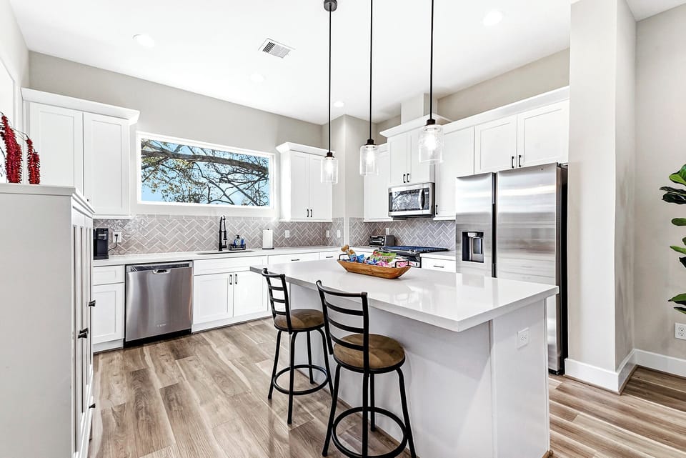 Open kitchen with large island perfect for meals or coffee.