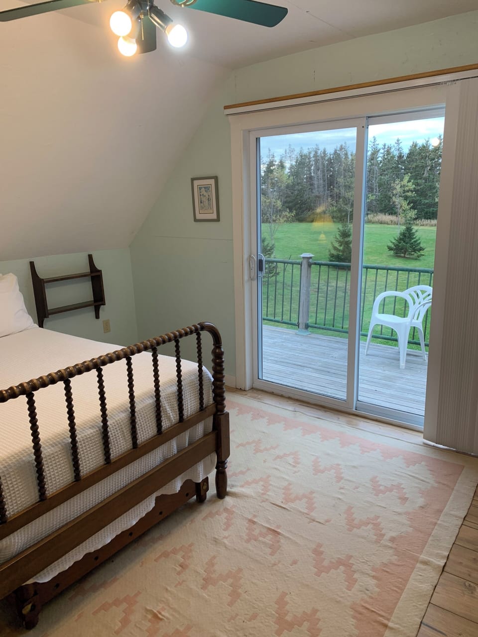 Barn 4 is an upper level bedroom with three quarter bed, single trundle bed, a balcony with water view, AC, and a refrigerator