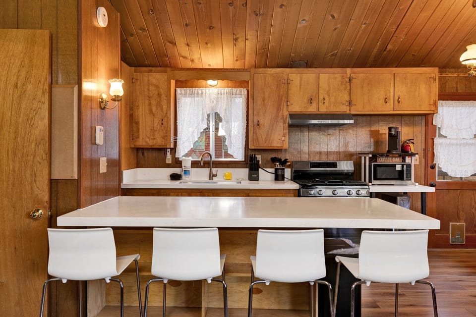 Fully equipped cabin kitchen with ample cabinetry, stove, fridge, microwave, and coffee maker—perfect for cooking meals, morning coffee, and feeling right at home on your stay.