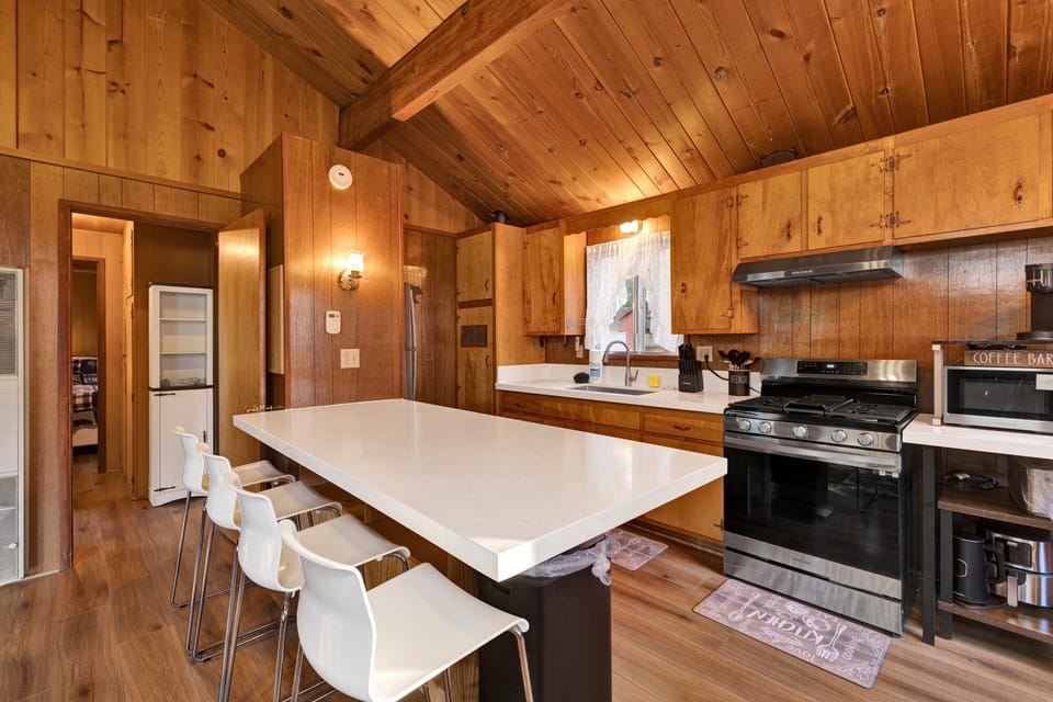 Fully equipped cabin kitchen with ample cabinetry, stove, fridge, microwave, and coffee maker—perfect for cooking meals, morning coffee, and feeling right at home on your stay.