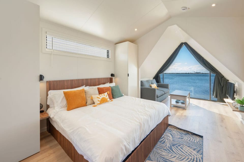 A king size bed with a breathtaking view of the beautiful sea