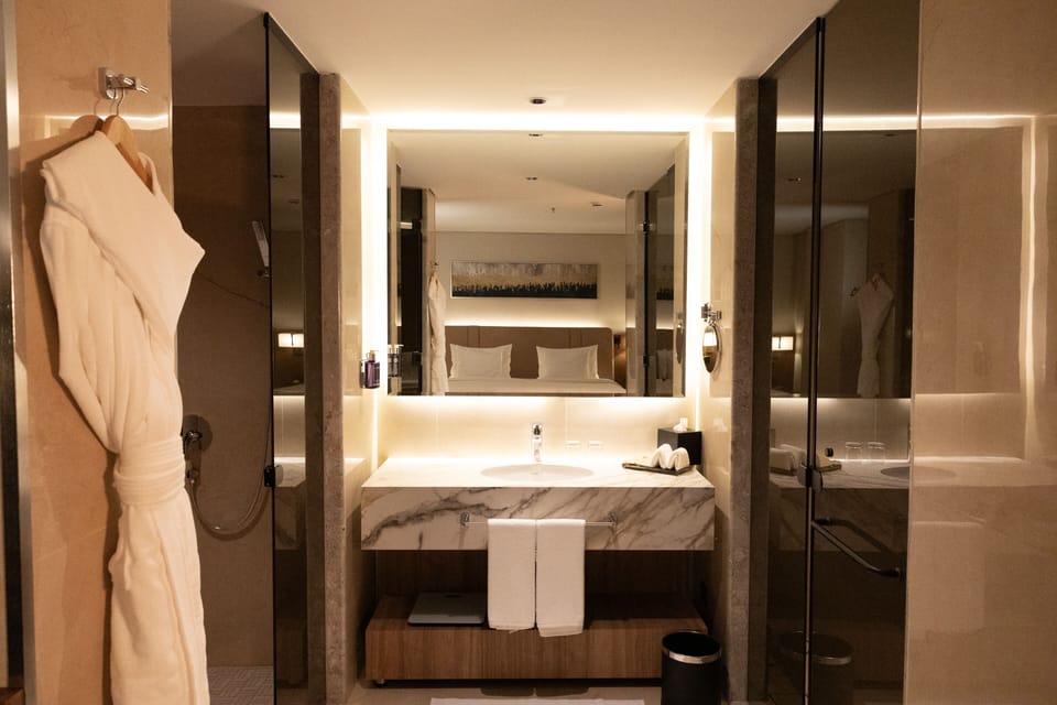Separate tub and shower, hair dryer, slippers, towels