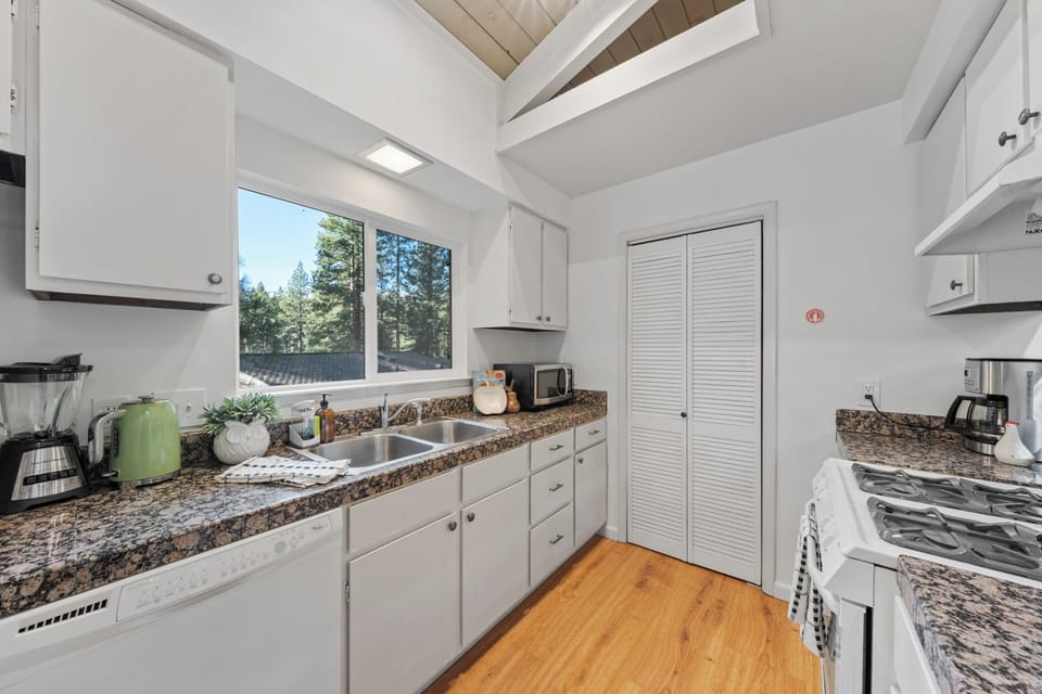 Kitchen window view with white cabinetry and natural light.