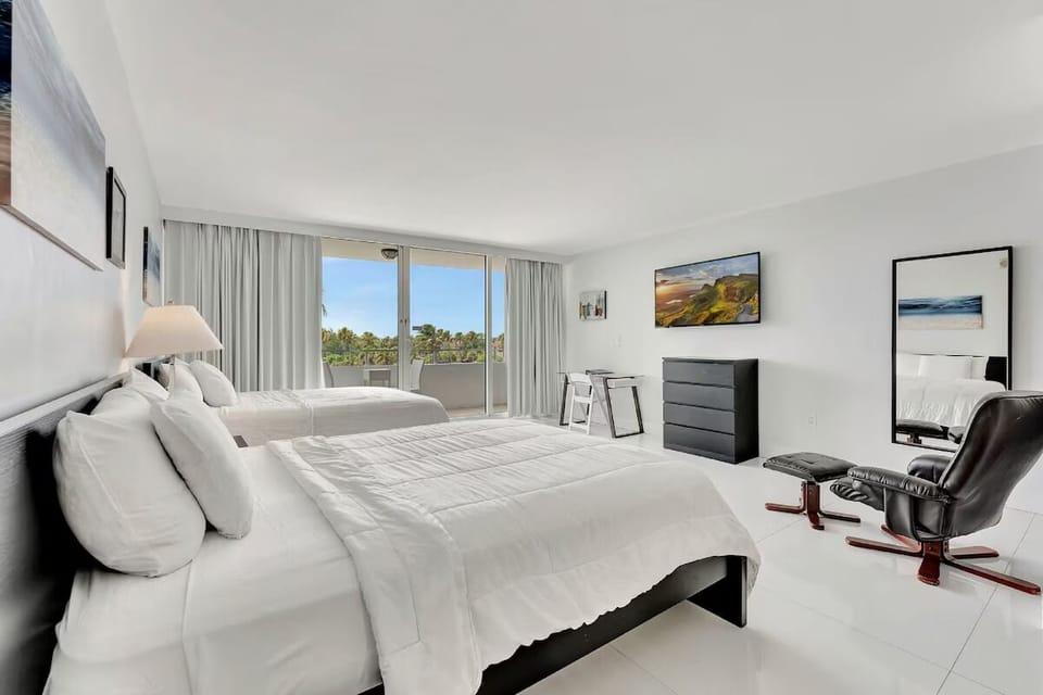 Unwind in crisp white beds with breezy balcony outlook.
