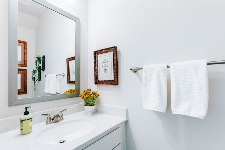 Bright, modern vanity with natural textures and charming rustic accents.