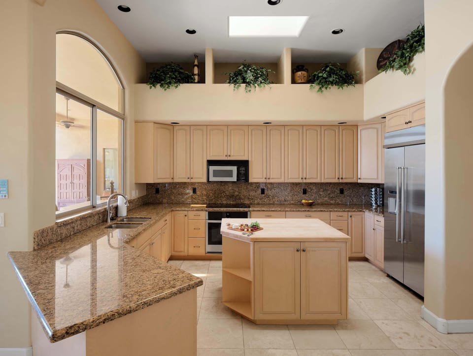 Fully equipped kitchen with stainless steal appliances, a kitchen island, ample counter space, dedicated work space, and breakfast nook.