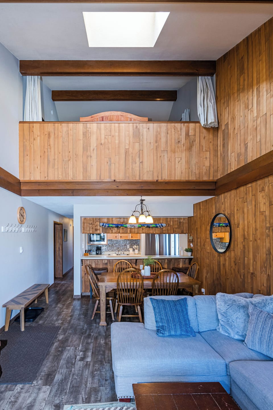 Relax in your spacious two-story retreat with soaring ceilings, warm wood accents, and an open layout connecting cozy seating to the dining area.