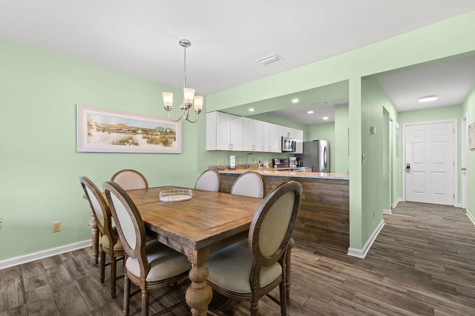 Sit down to a meal in the warm dining area w/ an elegant chandelier & an inviting, open feel.