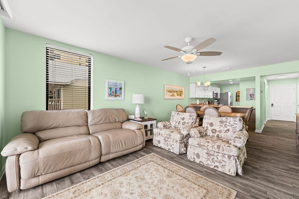 Spacious, light-filled living room w/ plush seating — a welcoming retreat after a day at the beach.