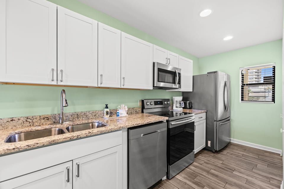 Fully equipped kitchen w/ granite counters, stainless appliances & room to prep your favorite meals.