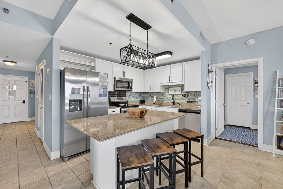 Modern kitchen with granite island and stainless steel appliances