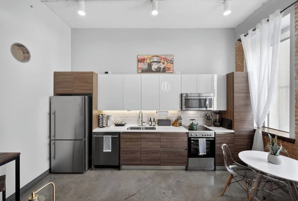 Bright & Functional Kitchen Layout: Streamlined design with generous counter space, sleek finishes, and under-cabinet lighting, creating a practical yet visually appealing cooking area.