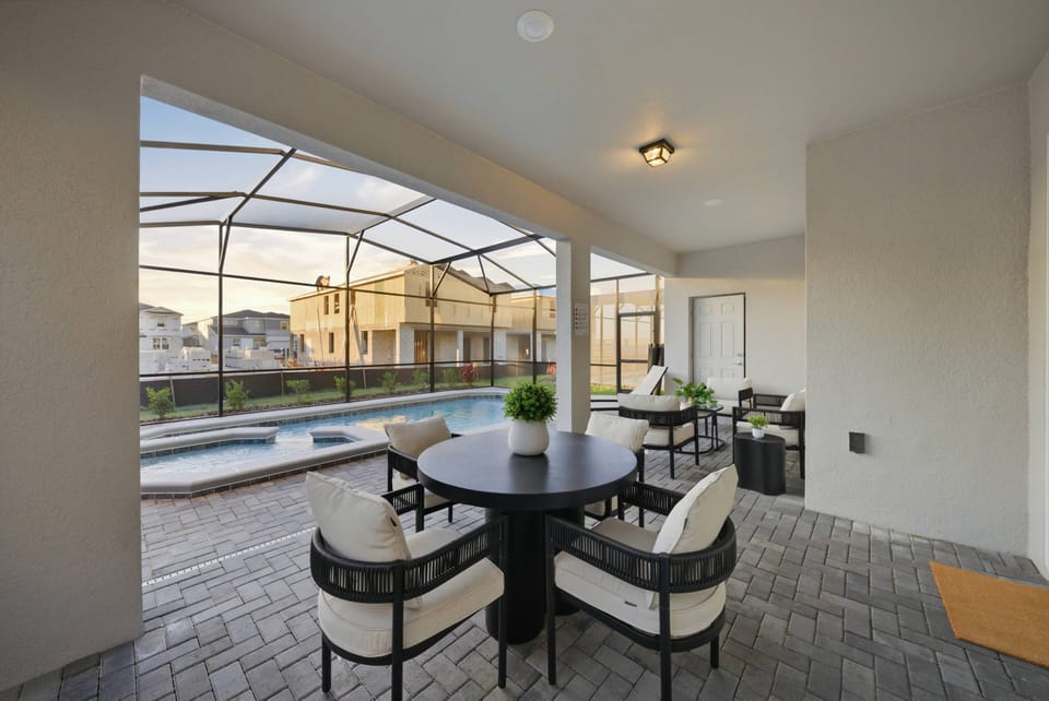 Step into your own private oasis with a sparkling pool surrounded by sleek tile and a modern screened enclosure. Enjoy the afternoon sun on the comfortable lounge chairs, creating the ideal spot for relaxation and socializing.