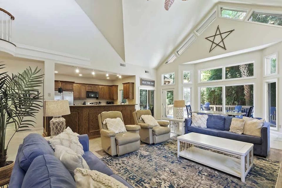 Relax in your spacious living area with soaring ceilings, abundant natural light, and comfortable seating perfect for gathering.
