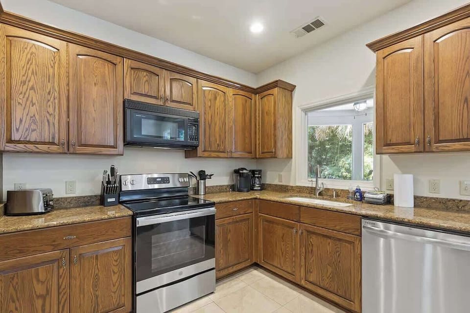 Your fully-equipped kitchen features warm wood cabinets, granite counters, and stainless appliances for memorable home-cooked meals.