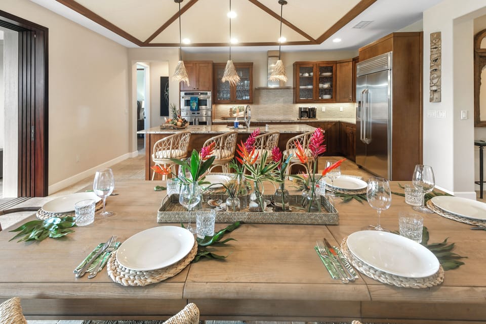 Gather around this stunning dining table where memorable meals await, perfectly set for your group with beautiful tropical touches.