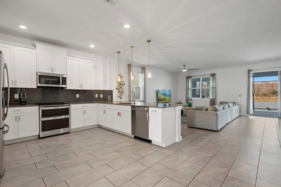 This kitchen is where family meals come to life. The open design makes it easy to chat with loved ones while you cook, and the beautiful bar stools create a comfortable place to gather around the island. 