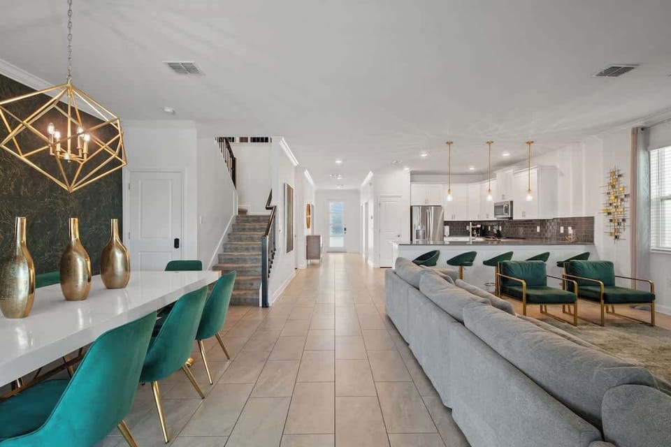 Spend quality time with loved ones in this beautifully designed living room, where comfort meets style. The spacious sectional offers plenty of room to spread out and relax, while the elegant lighting and accents create a warm, inviting atmosphere.