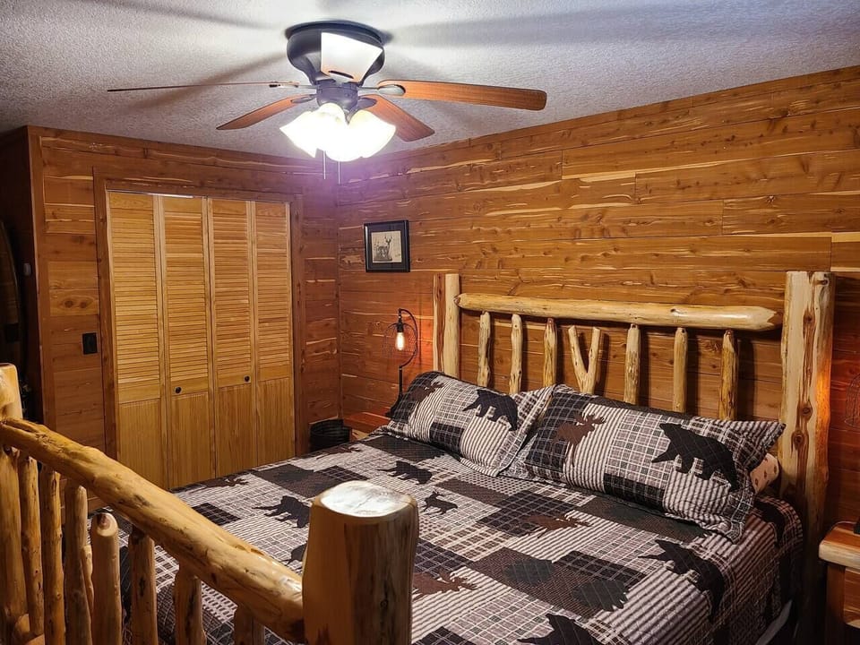 King size cedar post bed and side lamps with Eisenhower light bulbs.
