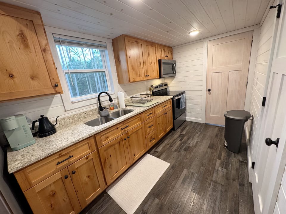 Kitchen with oven, stove, microwave