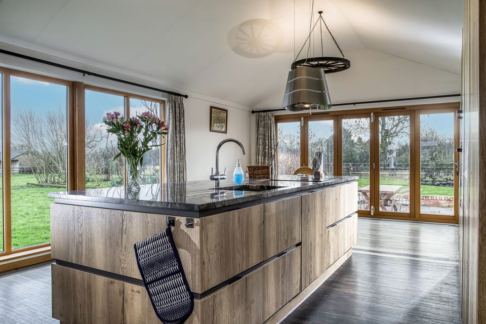 The impressive granite topped island with magnificent views from the dual aspect doors and windows