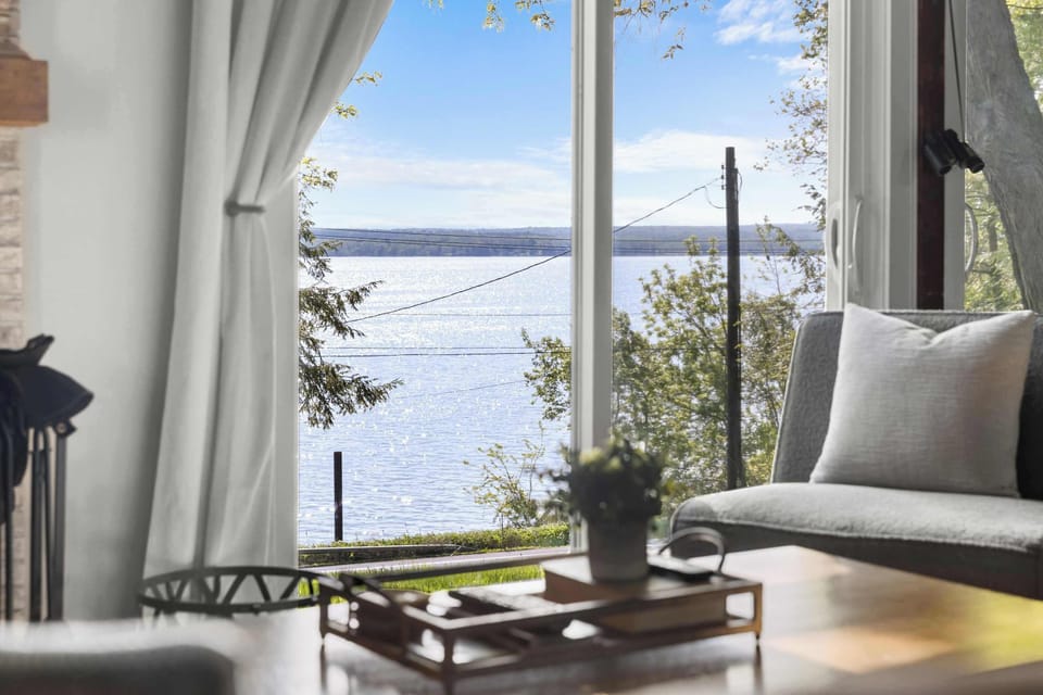 The glass doors frame beautiful lake views, bringing the outdoors right into the living room.