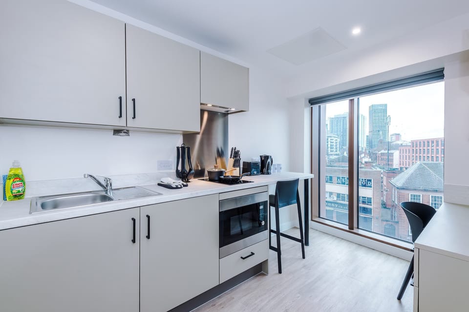 Kitchenette with city views, suitable for light cooking during longer stays.