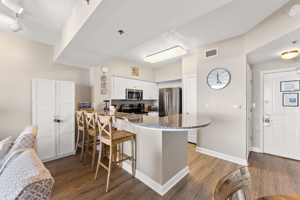 Updated kitchen with granite countertops, stainless appliances, and bar seating for casual dining.