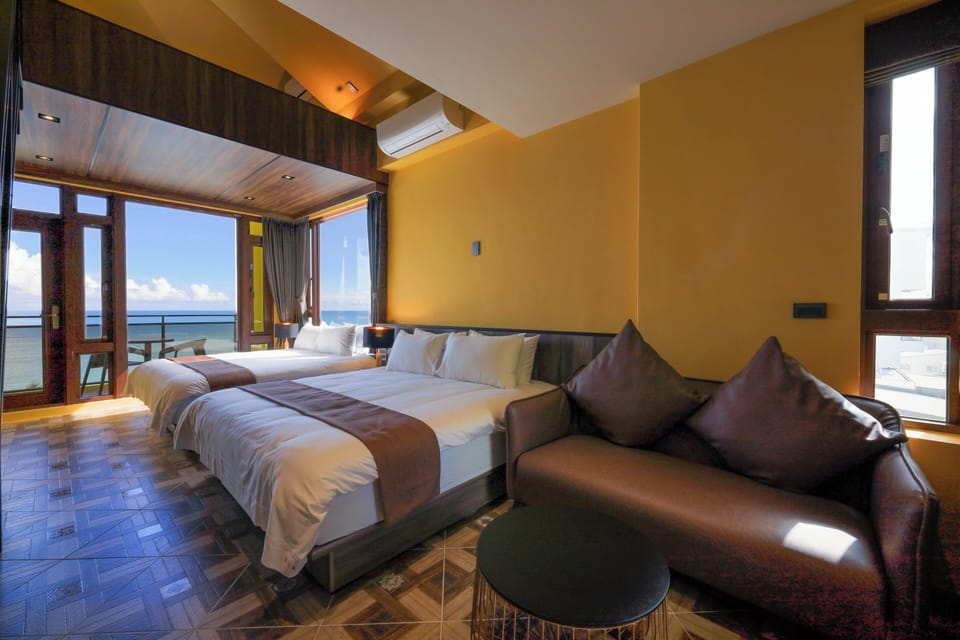 Deluxe Quadruple Room, 2 Queen Beds, Balcony, Sea View | Minibar, individually decorated, individually furnished, soundproofing