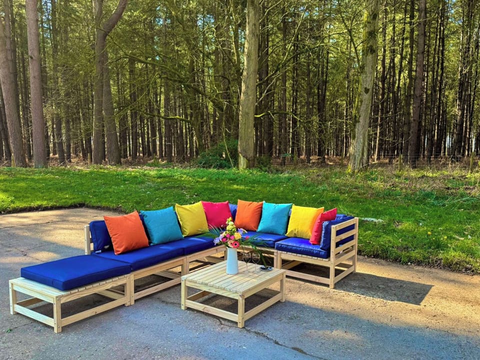 Outdoor seating area with forest view | Falconer&rsquo;s Lodge, High Ash