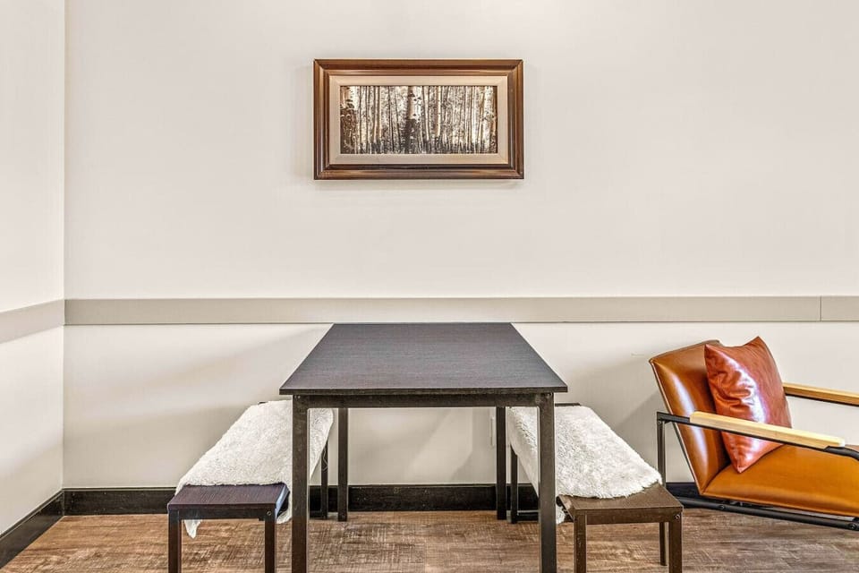 The dining area features a cozy setup with seating for four.
