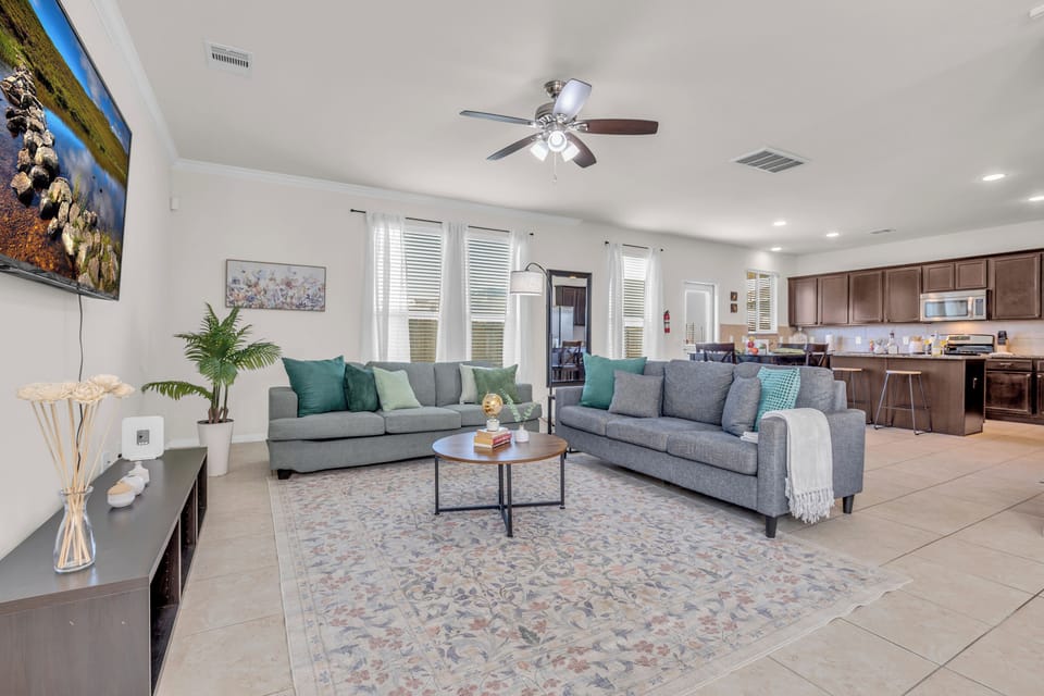 Spacious living room area with seating for 6 and a 65 inch TV