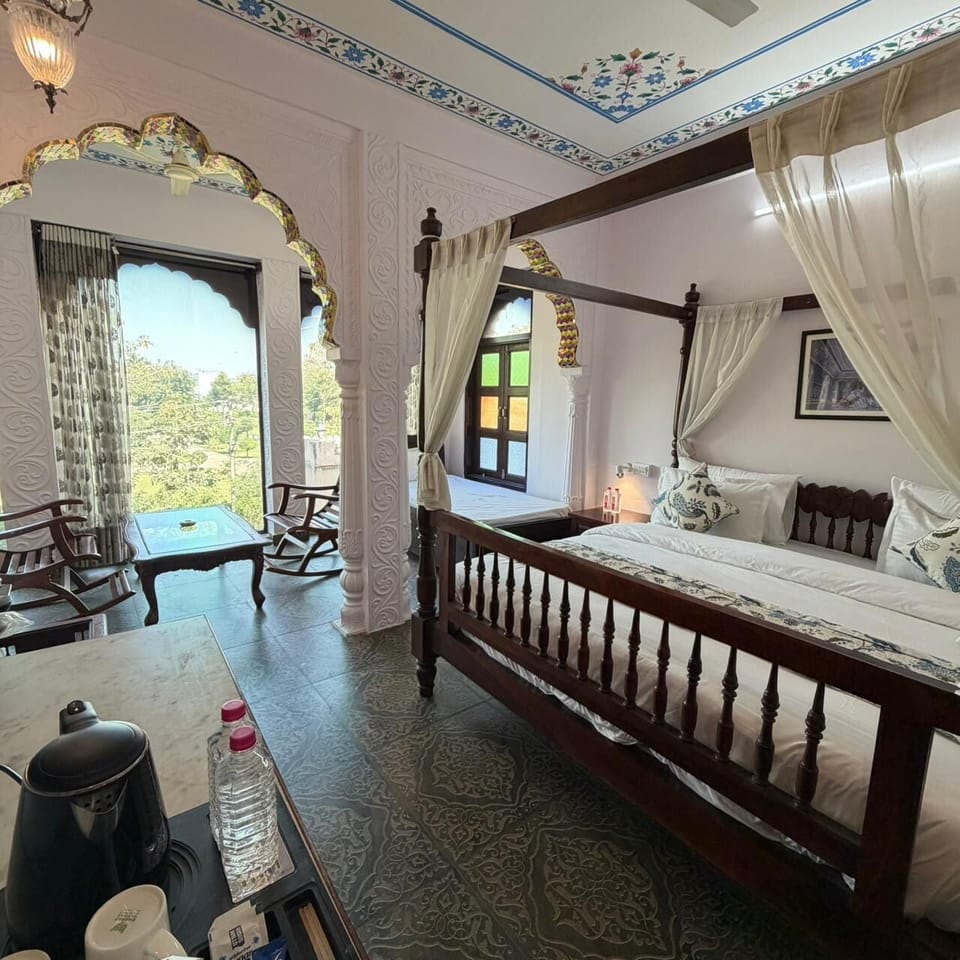 Luxury Suite, Garden View | In-room safe, desk, laptop workspace, iron/ironing board