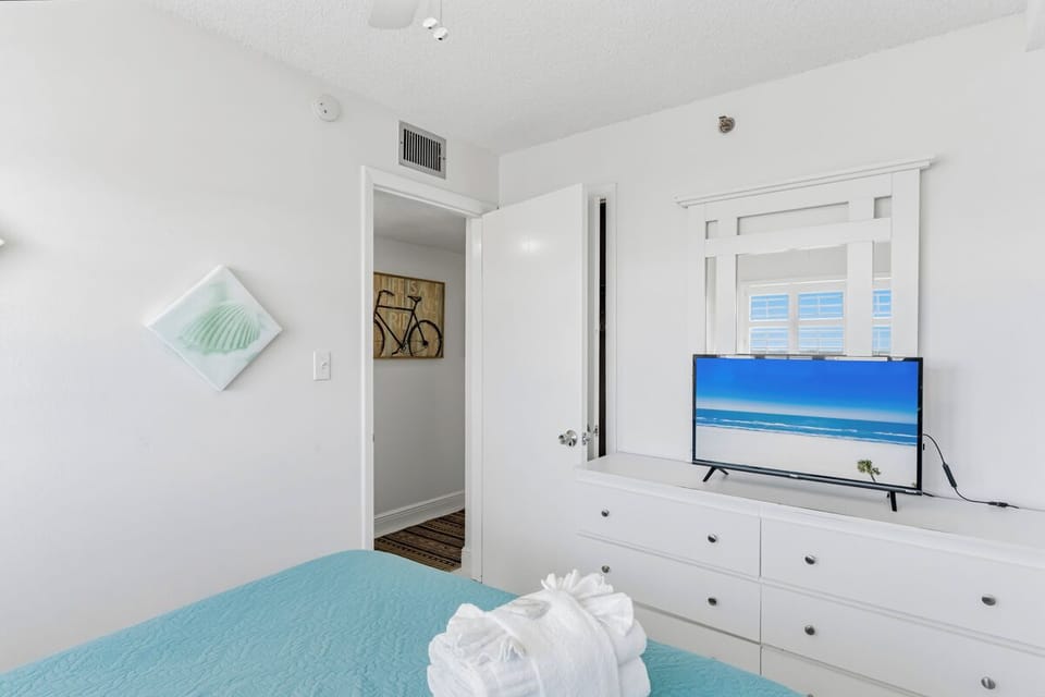 Your bright bedroom features crisp linens, a TV for relaxing evenings, and thoughtful touches that make it feel like home.