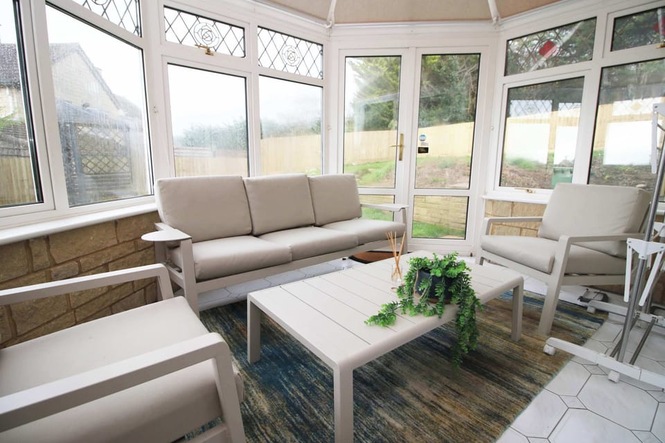 Bright conservatory overlooking the garden, perfect for morning coffee or quiet evenings