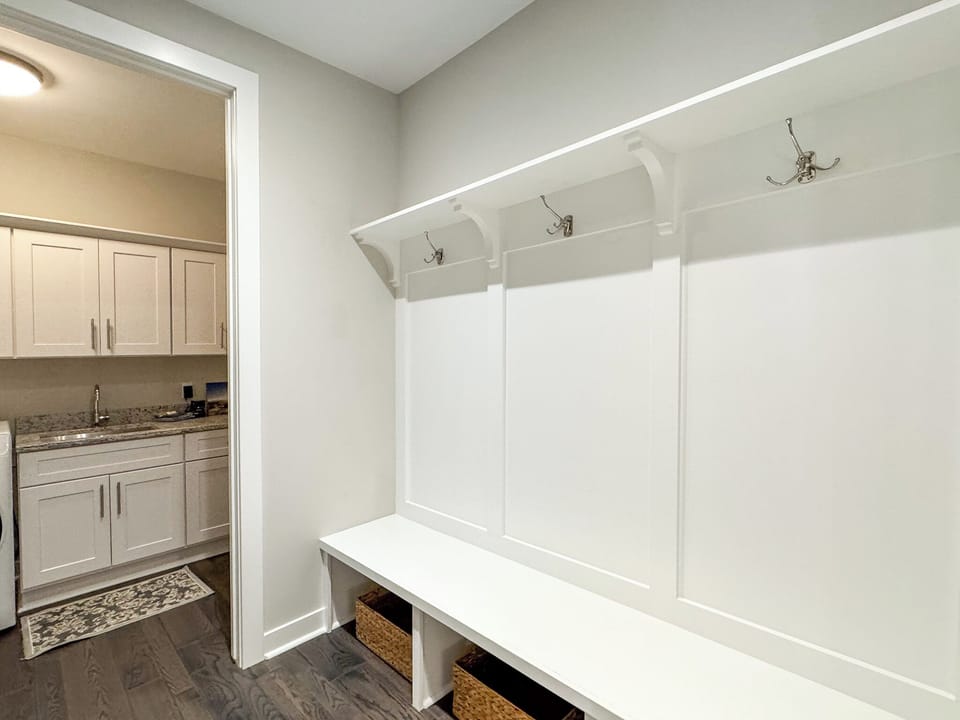 Mud room area for hanging coats and storing outdoor gear.