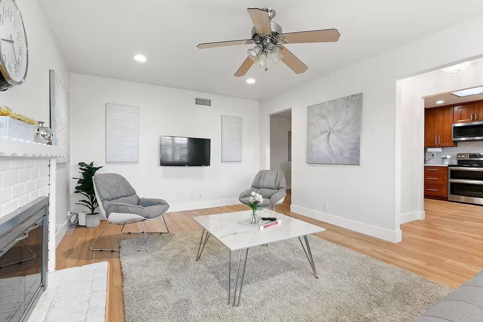 Comfortable living room with a smart HD TV and cozy chairs for lounging.