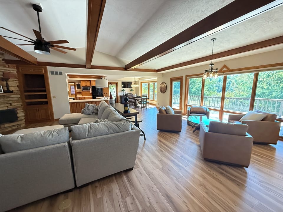 Large open living room, kitchen, and dining room.   2 TVs, lots of seating. 