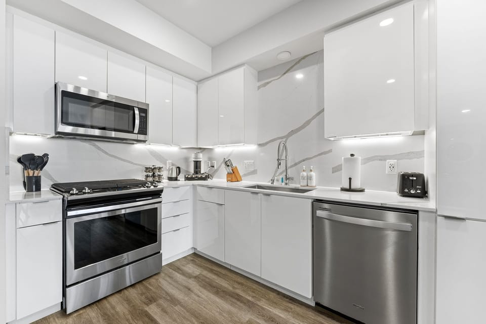 Fully equipped designer kitchen with high-end finishes and a gas range.