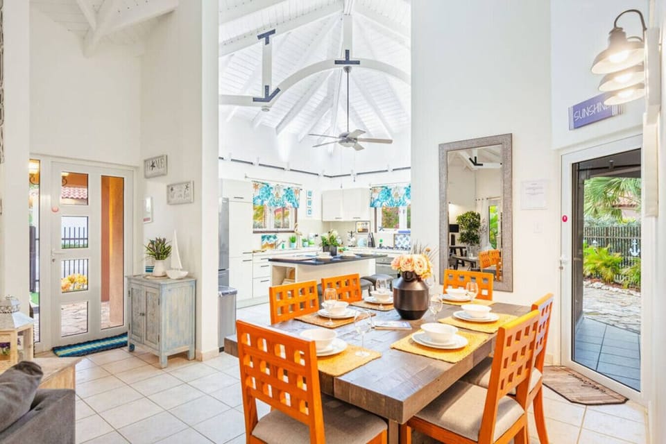 Dine in style! Gather around the large wooden table for family meals, with easy access to the kitchen and outdoor patio.